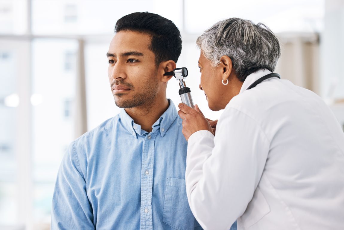 physician using otoscope to check for acoustic neuromas
