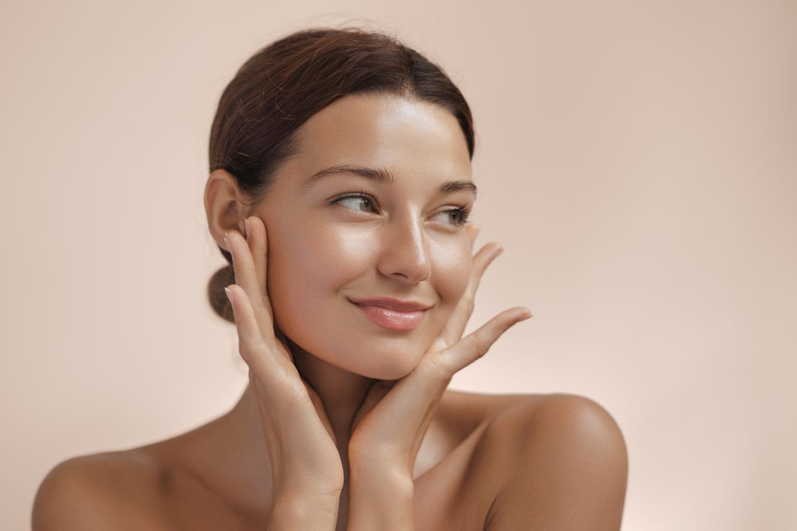 woman feeling face after facelift
